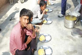 Children sit with their friends for the first time in almost a year